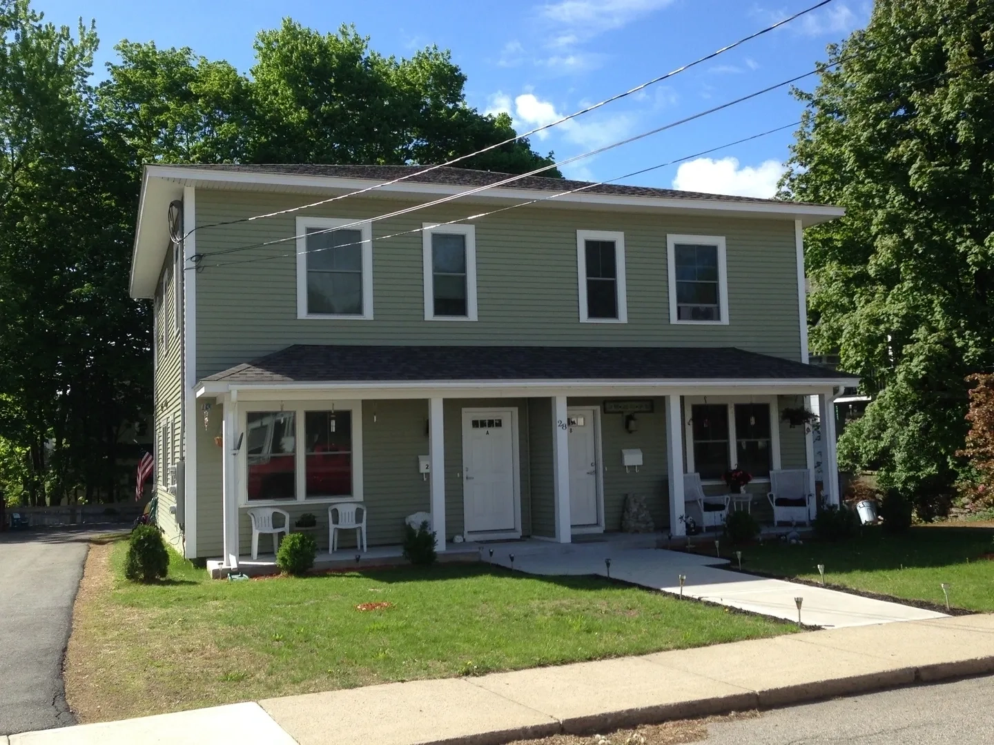 A house with two floors and a porch.