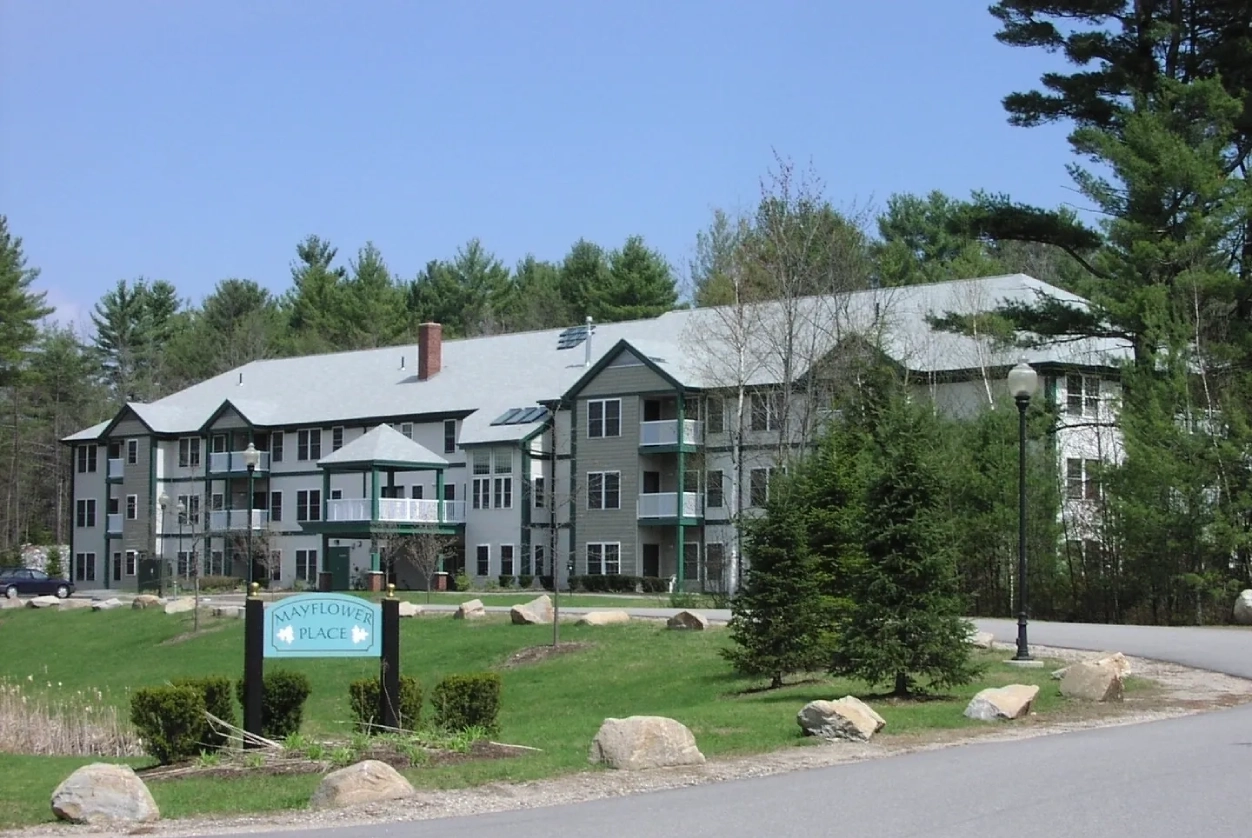 A large building with many windows and trees